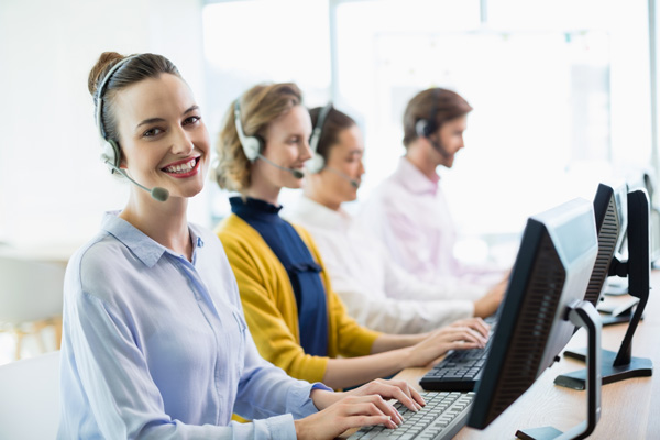 customer-service-executives-working-in-call-center-2QGYTNV